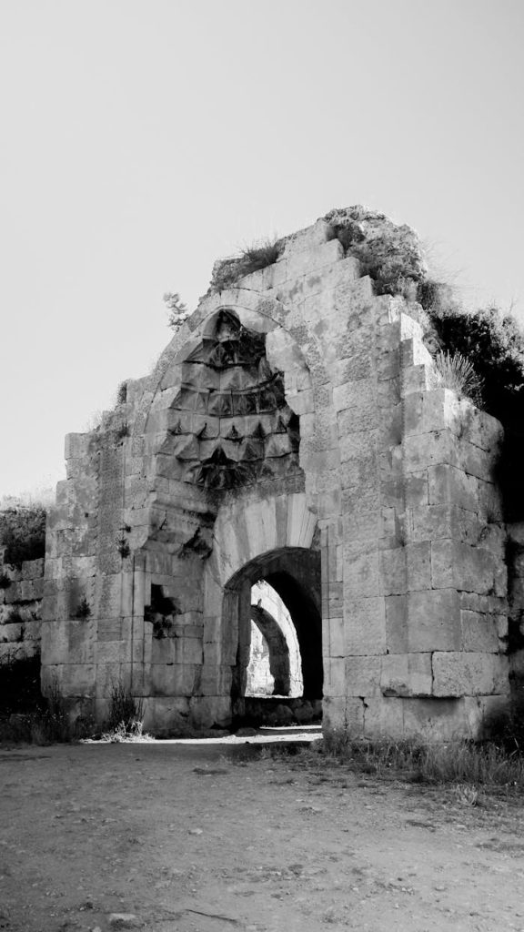 Explore the historic architecture of Evdir Han's stone ruins captured in black and white.